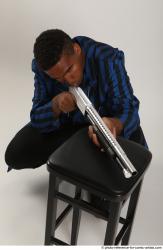 Man Adult Average Black Kneeling poses Casual Fighting with shotgun